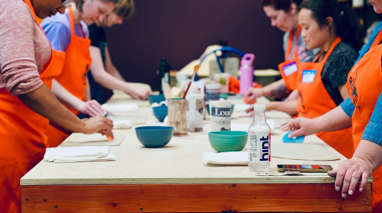 High angle view of pottery tools and clay on a worktable