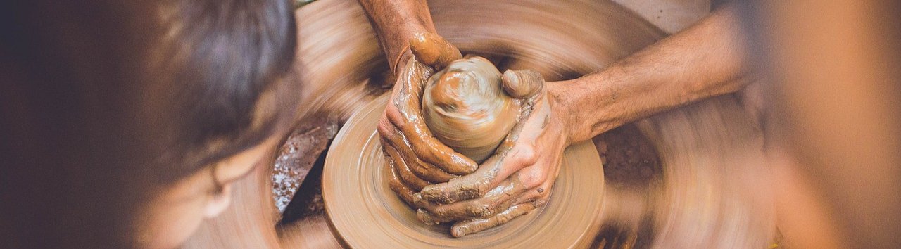 High-angle view of an artist working with clay on a potter's wheel
